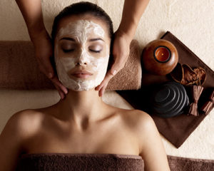 Woman with a cosmetic mask on her face