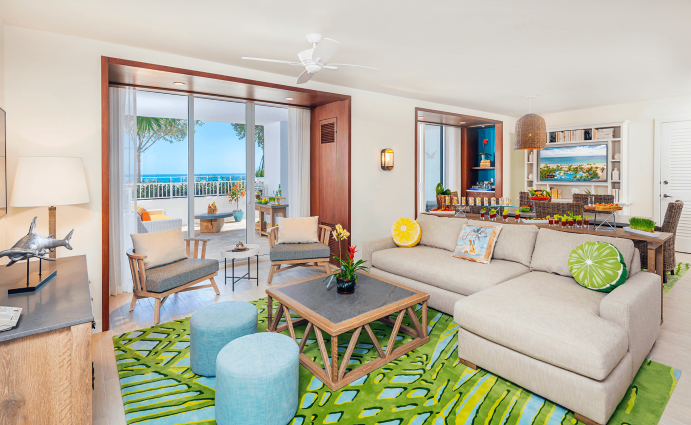 Living room with contemporary furnishings, one sofa, two armchairs, table and two large windows