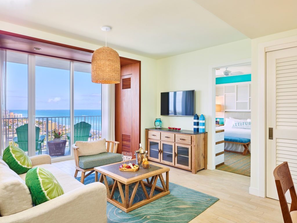 Living room contemporary furnishings with one sofa, armchair, table, tv, large window and balcony