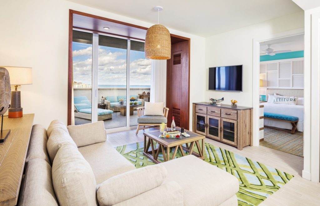 Living room contemporary furnishings with one sofa, armchair, table, tv, large window and veranda